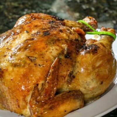 a sriracha glazed roast chicken on a platter