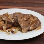 top sirloin steaks marinated with onions