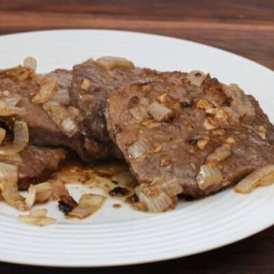 marinated steak and onions on a plate