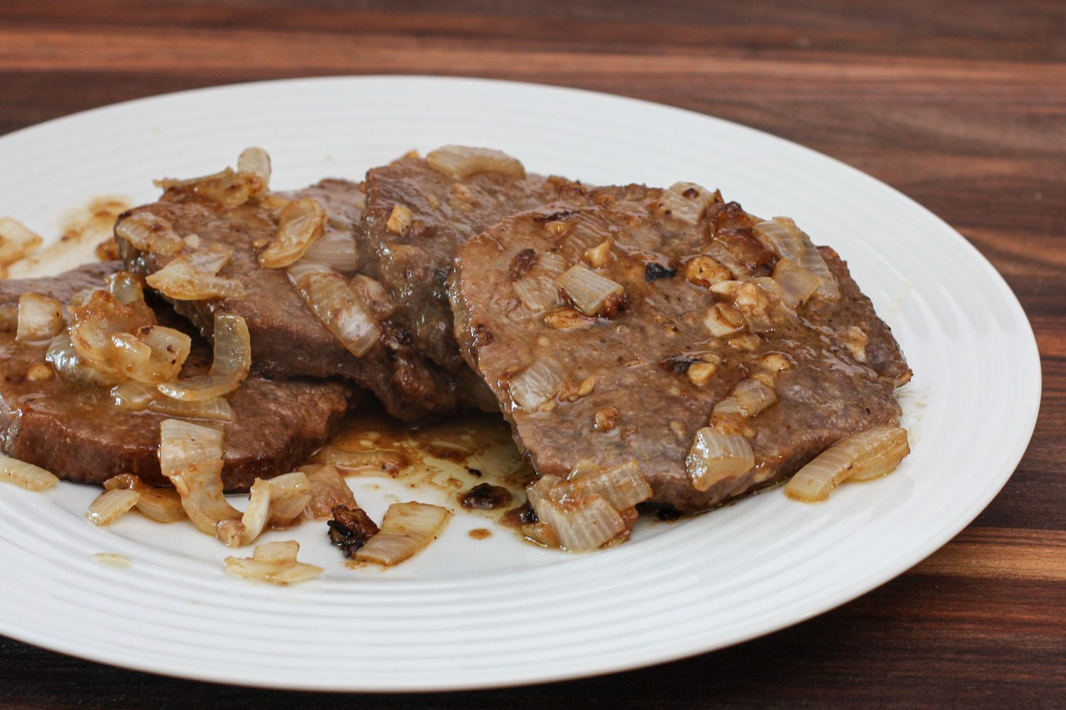 marinated steak and onions on a plate