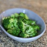 A small dish with fresh steamed broccoli