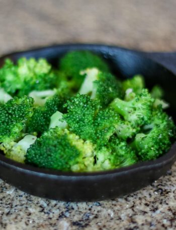 steamed broccoli in a small cast iron serving pan