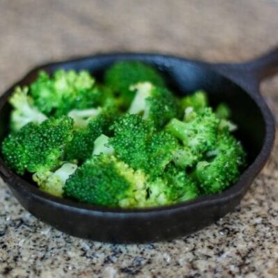 steamed broccoli in a small cast iron serving pan