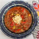stuffed pepper soup in a large bowl with rice, peppers, and tomatoes