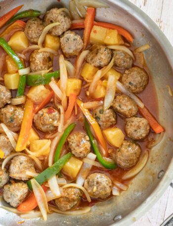 sweet and sour pork meatballs with stir-fried vegetable in the pan