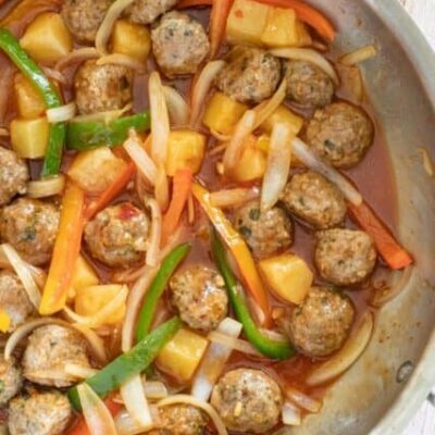 sweet and sour pork meatballs with stir-fried vegetable in the pan