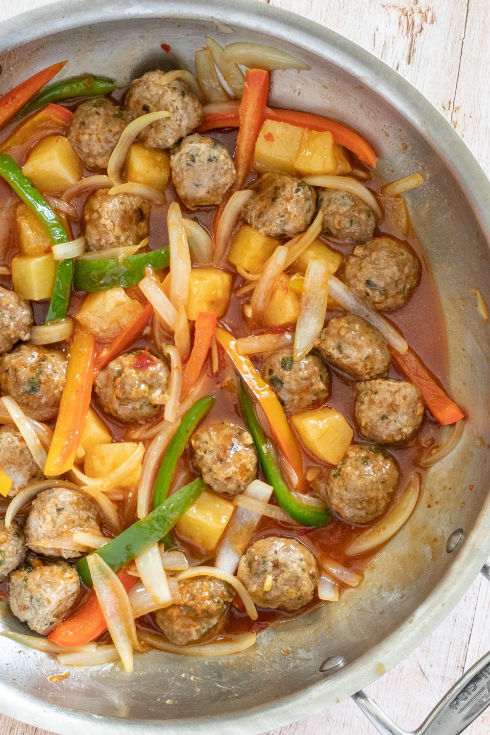 sweet and sour pork meatballs with stir-fried vegetable in the pan
