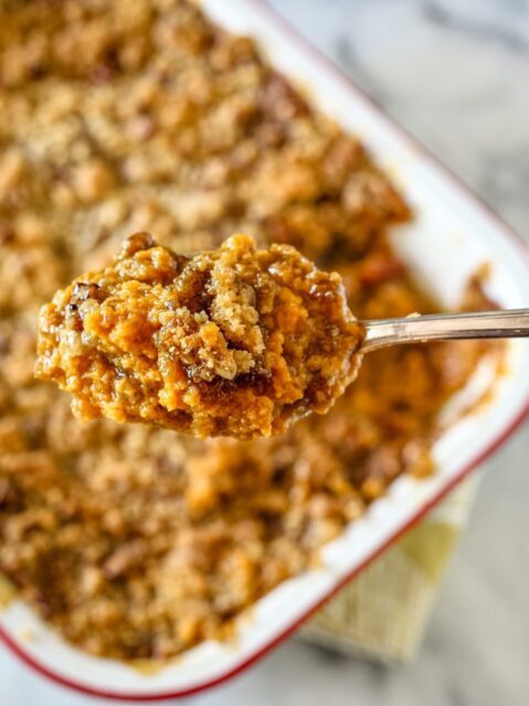 sweet potato casserole with coconut and pecans in a baking dish