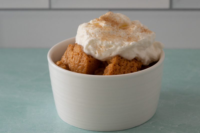 a serving of sweet potato pudding with whipped topping and cinnamon sugar