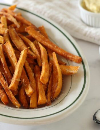 Baked sweet potato fries on a plate with sweet chili mayo