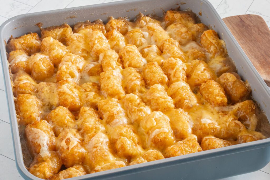 baked tater tot casserole with melted cheese on top