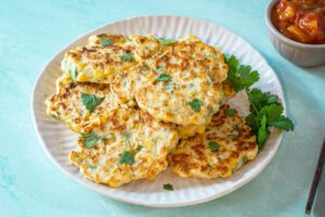 Tex Mex corn fritters garnished with cilantro.