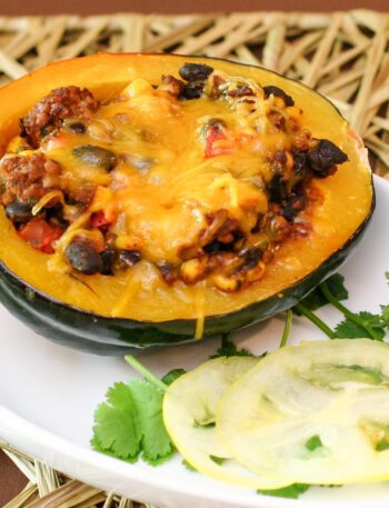 tex mex stuffed acorn squash with ground beef and black beans on a plate