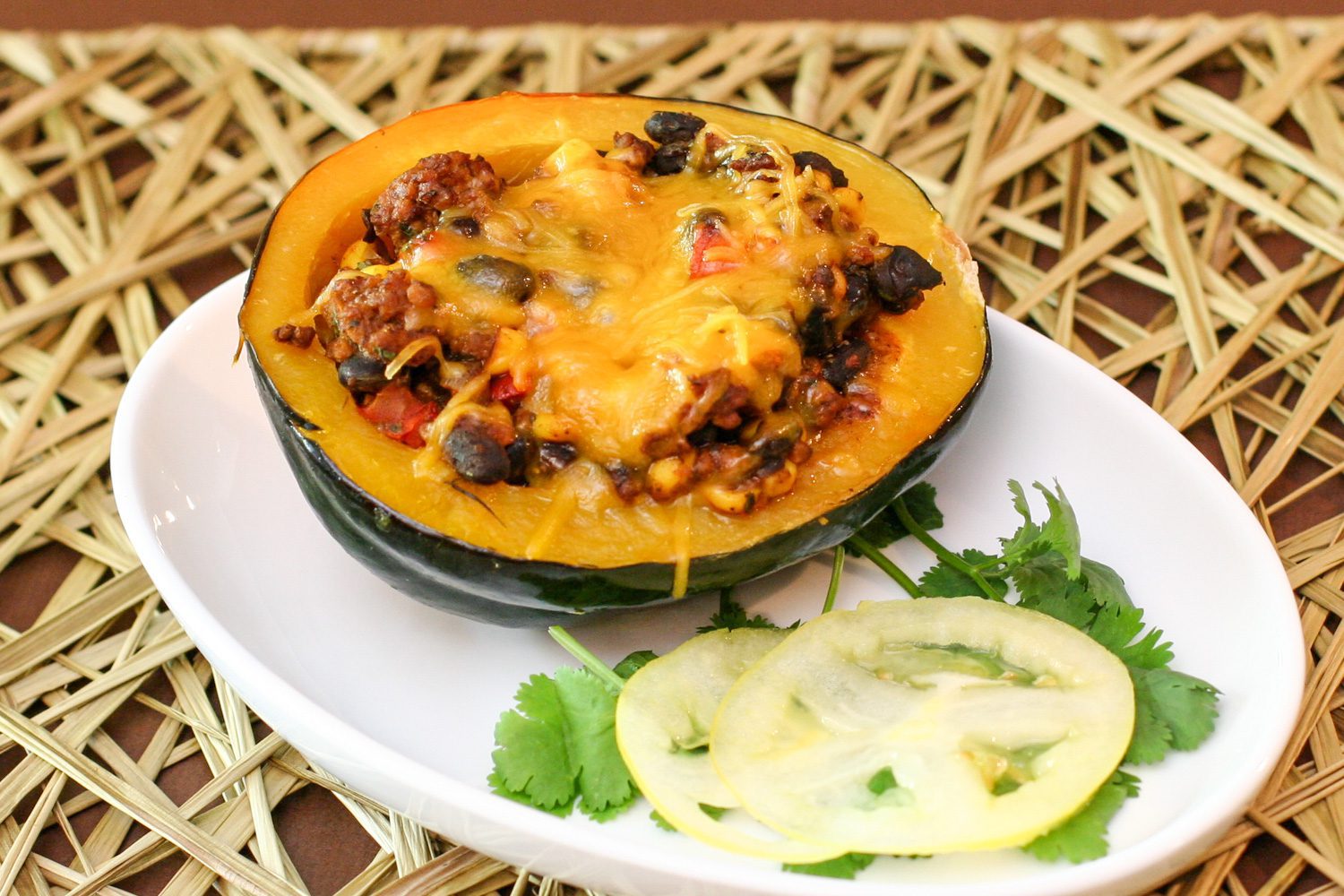 tex mex stuffed acorn squash with ground beef and black beans on a plate