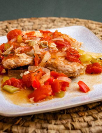 creole style pork chops with tomatoes on a plate