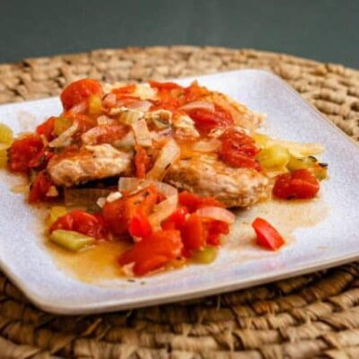 creole style pork chops with tomatoes on a plate