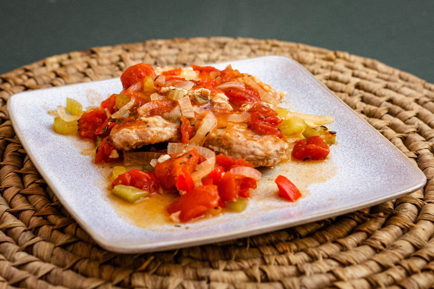 creole style pork chops with tomatoes on a plate