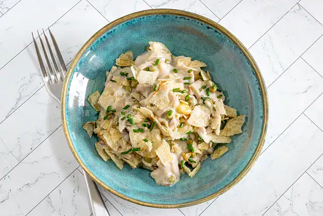 A serving of tuna casserole with potato chip topping.