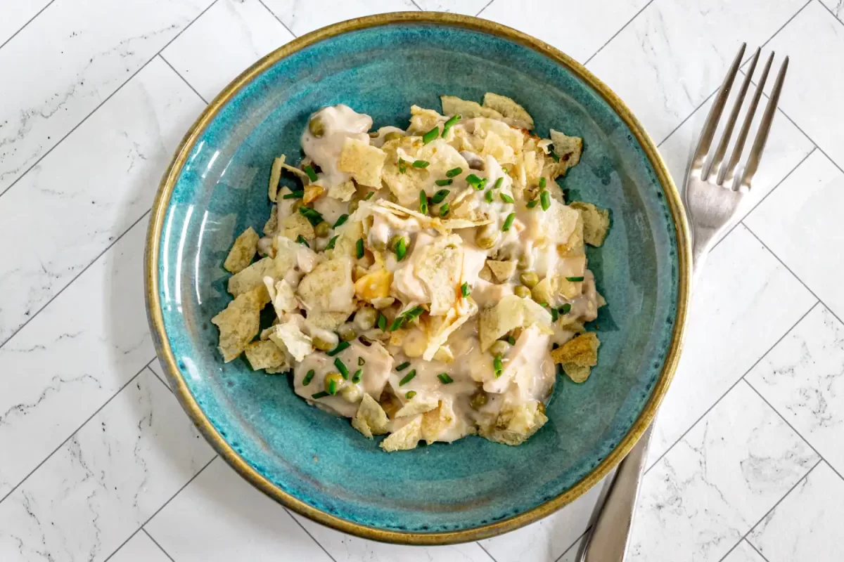 A serving of tuna casserole with potato chip topping.
