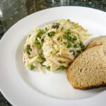 tuna and orzo pasta casserole on a plate with bread
