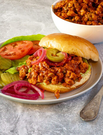 plate with sloppy joe sandwich and vegetables on the side