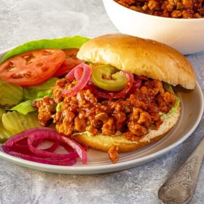 plate with sloppy joe sandwich and vegetables on the side