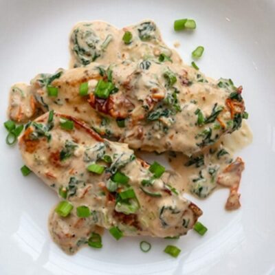 Creamy Tuscan chicken on a plate.