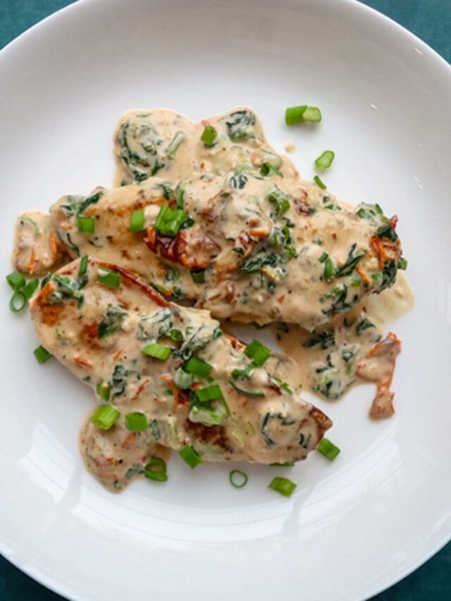 Creamy Tuscan chicken on a plate.