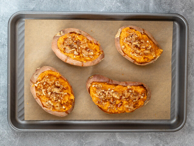 stuffed sweet potatoes on baking sheet