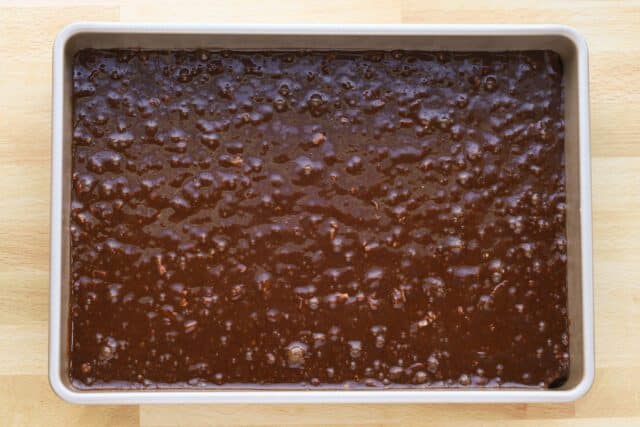 Brownie batter spread in the baking pan, ready to bake.