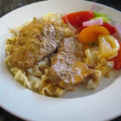 plate of veal steaks on noodles