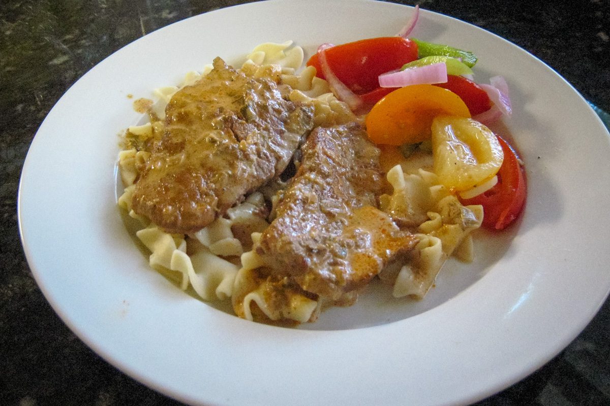 plate of veal steaks on noodles