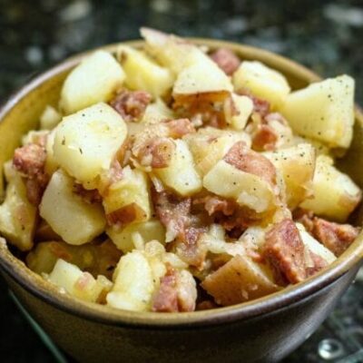 warm potato salad with sausage in a bowl