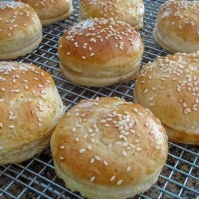 hamburger buns with sesame seeds on a cooling rack