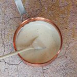 a copper saucepan with homemade basic white sauce